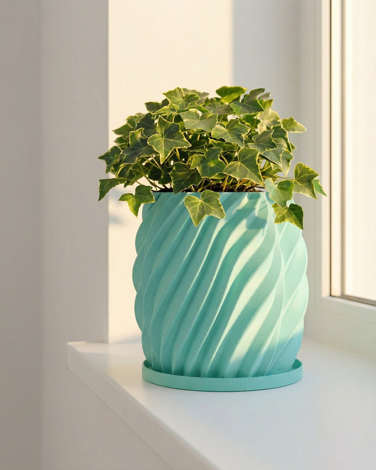 A light blue planter pot with a green ivy plant sits on a white windowsill next to a window.