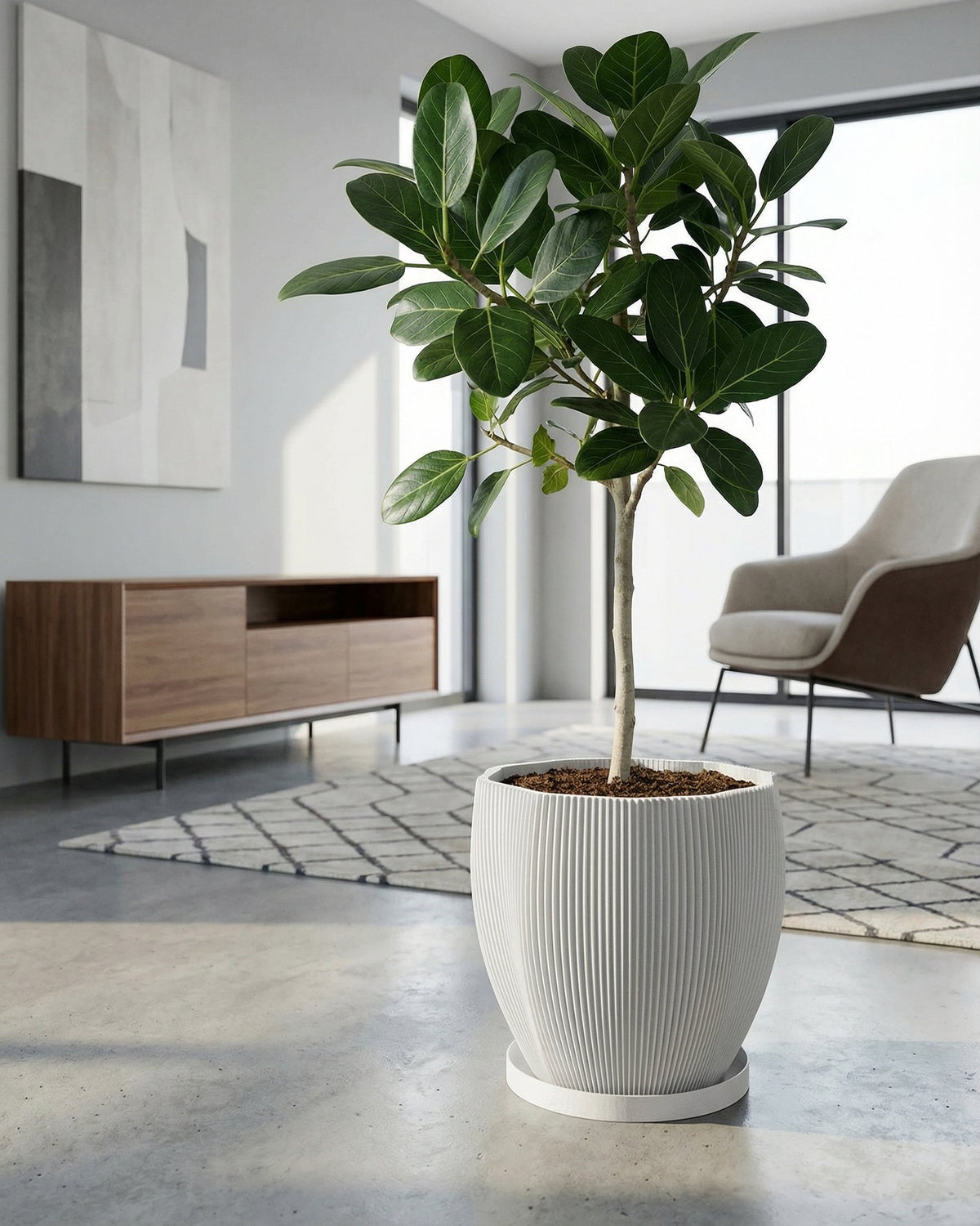A Pilea peperomioides plant sits in a white, textured planter on a dark wooden side table next to a gray couch.