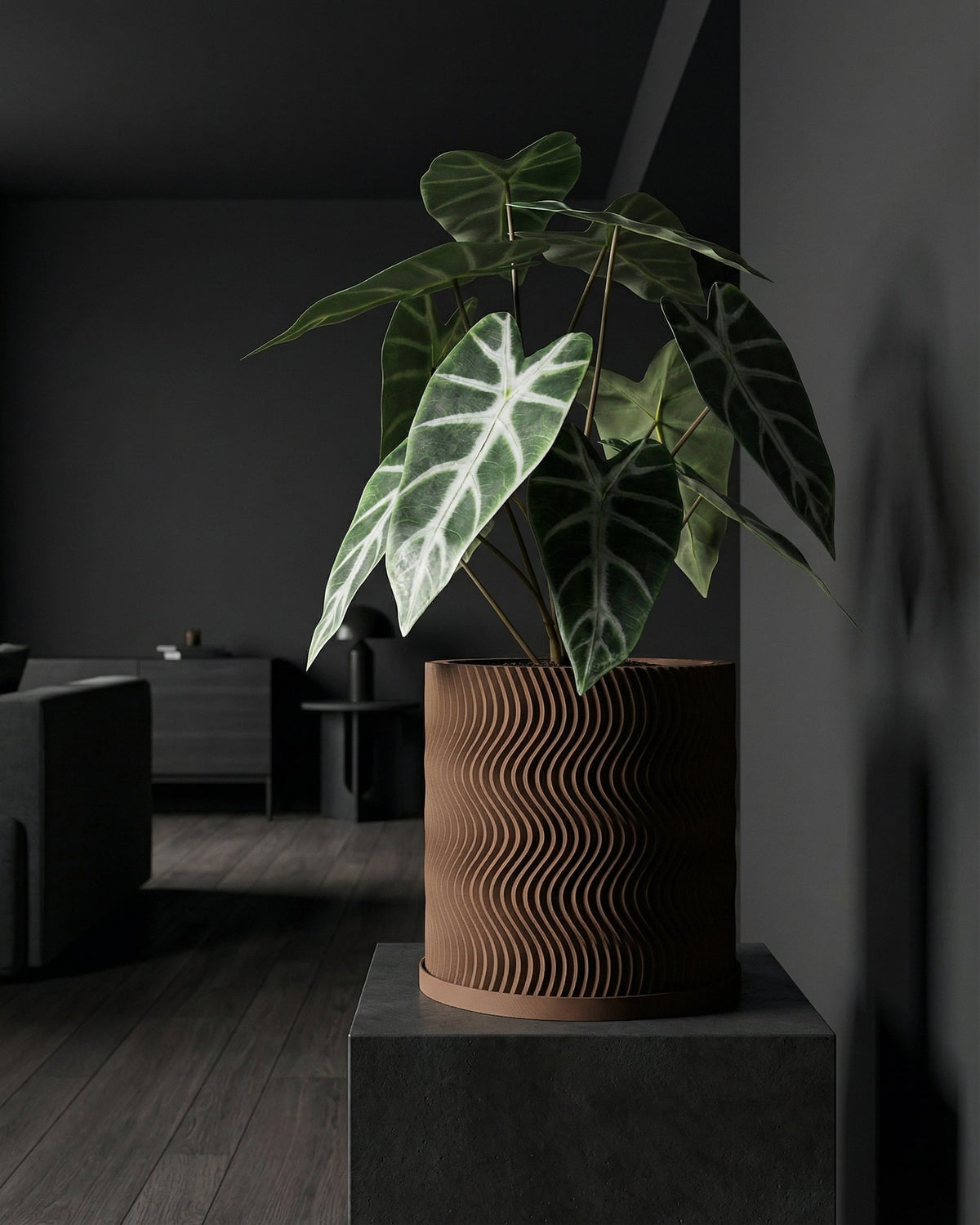 A planter pot with a wavy design sits on a dark gray stand, holding a plant with large, patterned leaves.
