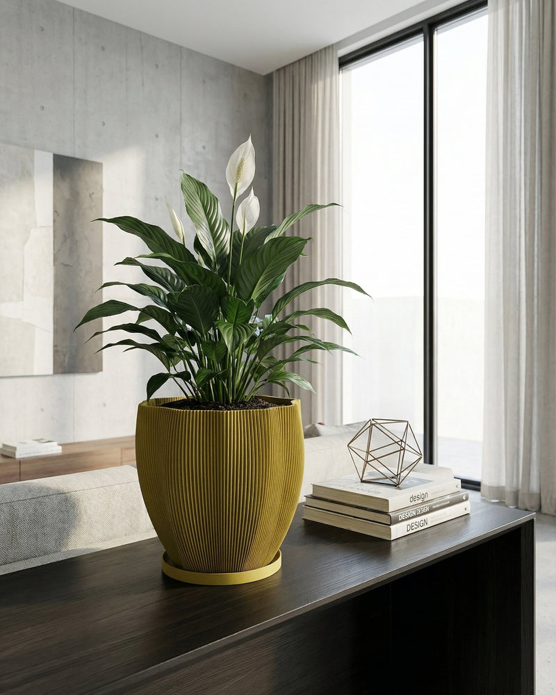 A vibrant pothos plant cascades from a textured, olive-green planter pot, sitting on a dark wood surface.
