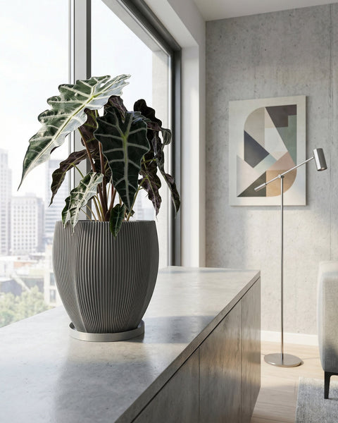 A gray planter pot with a green ivy plant sits on a wooden shelf against a rust-colored wall.