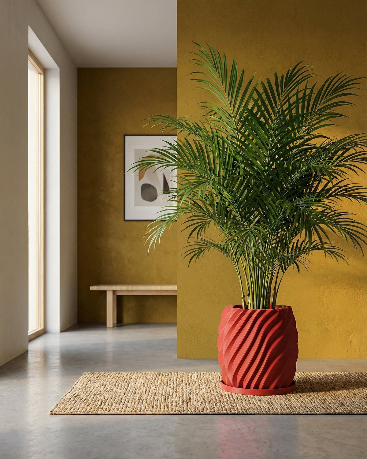 A red planter pot with a green plant sits on a woven rug in a room with a yellow wall.