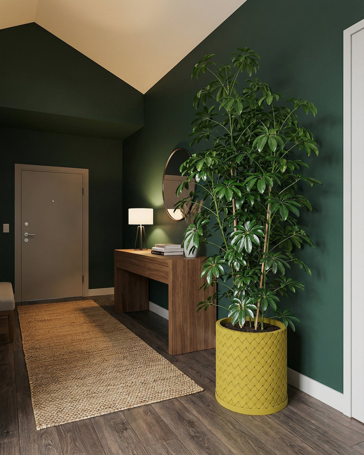 A green-walled entryway features a tall plant in a yellow woven planter pot, adding a pop of color to the space.