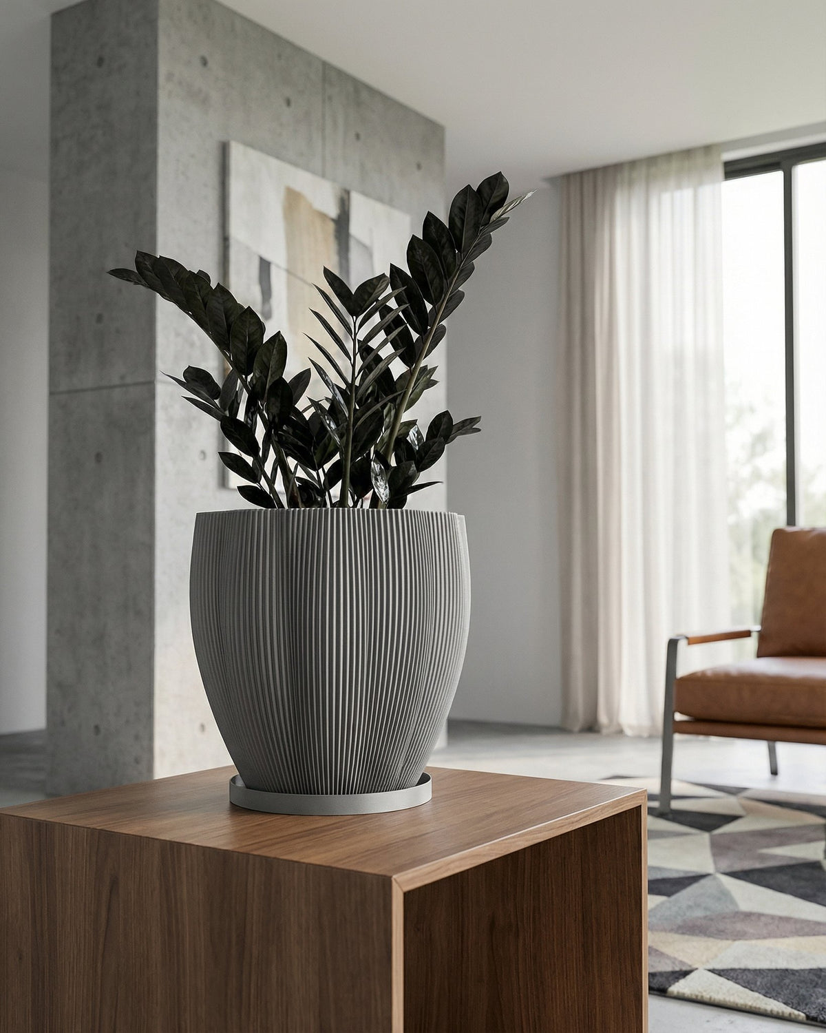 A Monstera plant in a textured gray planter pot sits on a white windowsill, bathed in sunlight.