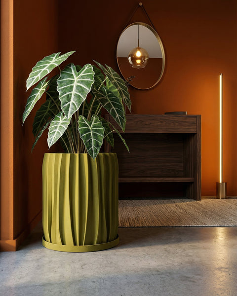 A yellow planter pot with a green plant sits on a windowsill, bathed in sunlight. The pot has a textured, swirling design.