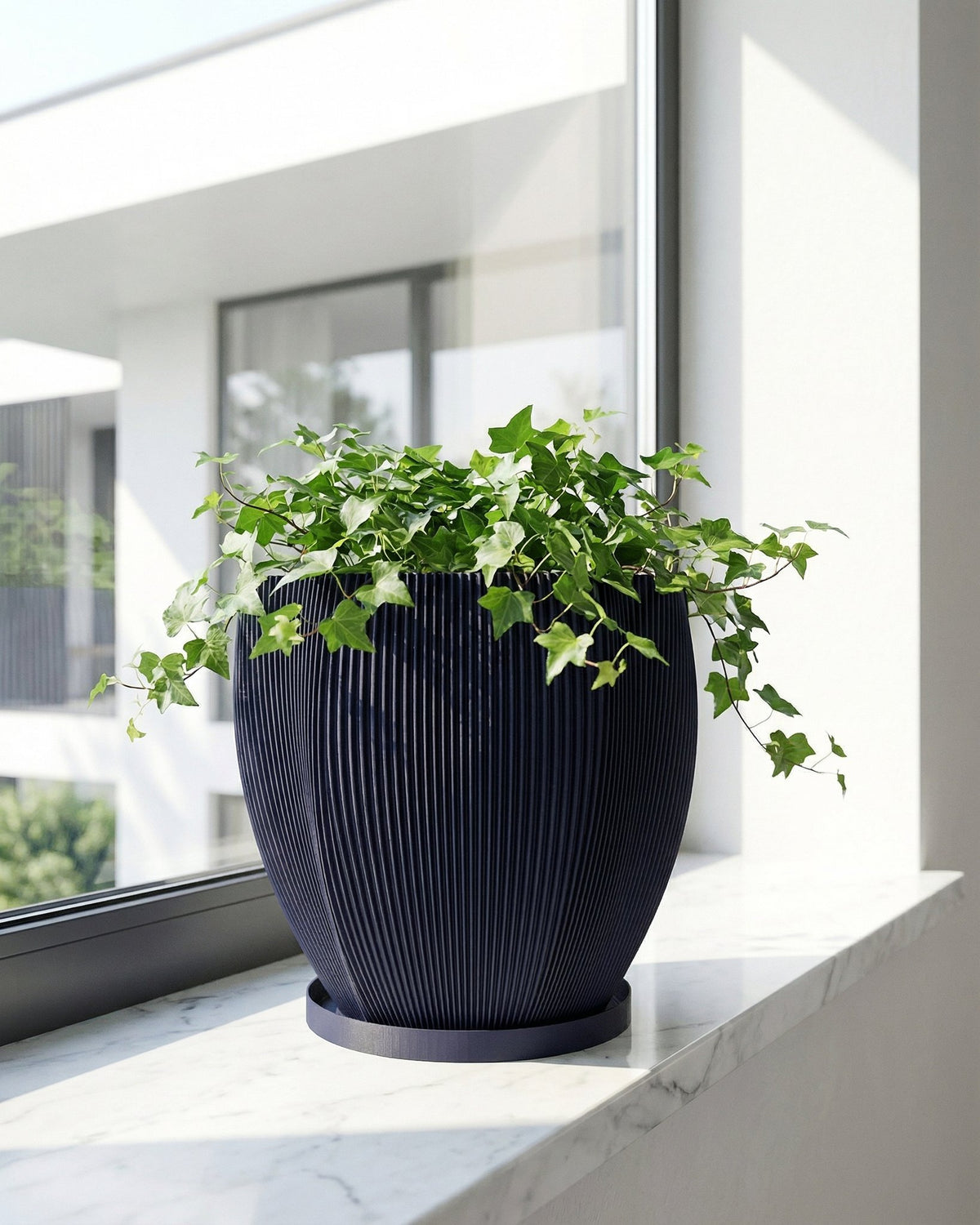 A blue planter pot with a textured design sits on a wooden bench, filled with a lush green plant with unique leaf shapes.