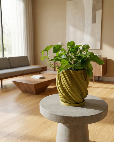 A yellow planter pot with a green plant sits on a windowsill, bathed in sunlight. The pot has a textured, swirling design.