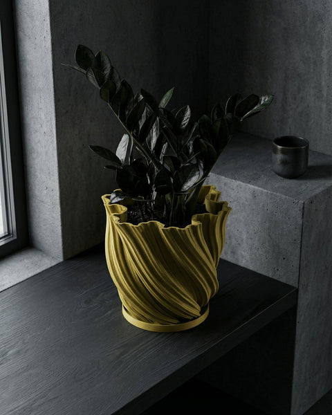 A vibrant pothos plant cascades from a textured, olive-green planter pot, sitting on a dark wood surface.