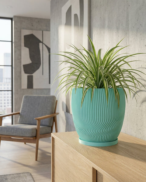 A turquoise planter with a spider plant sits on a wooden cabinet in a modern living room.