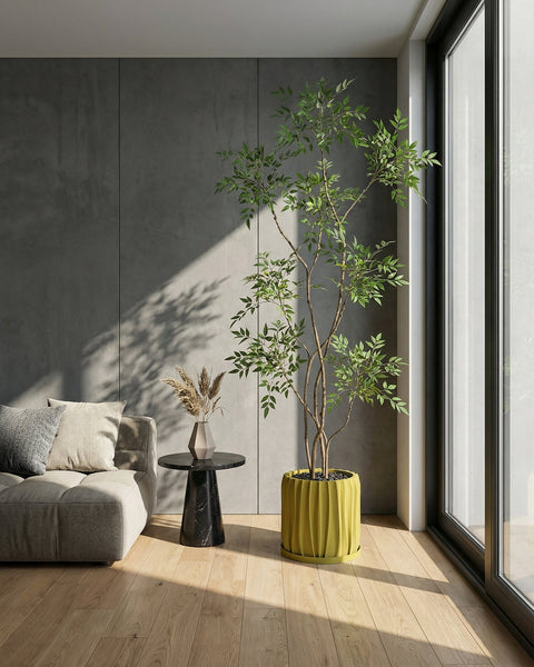 A vibrant pothos plant cascades from a textured, olive-green planter pot, sitting on a dark wood surface.