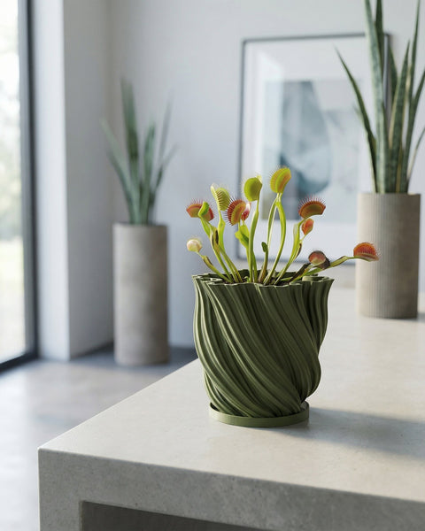 A green planter pot with a houseplant sitting on a windowsill.