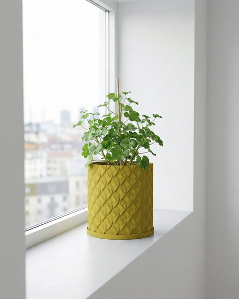 A vibrant plant in a textured, yellow planter pot sits atop a dark wooden table, adding a pop of color to the blue-toned room.