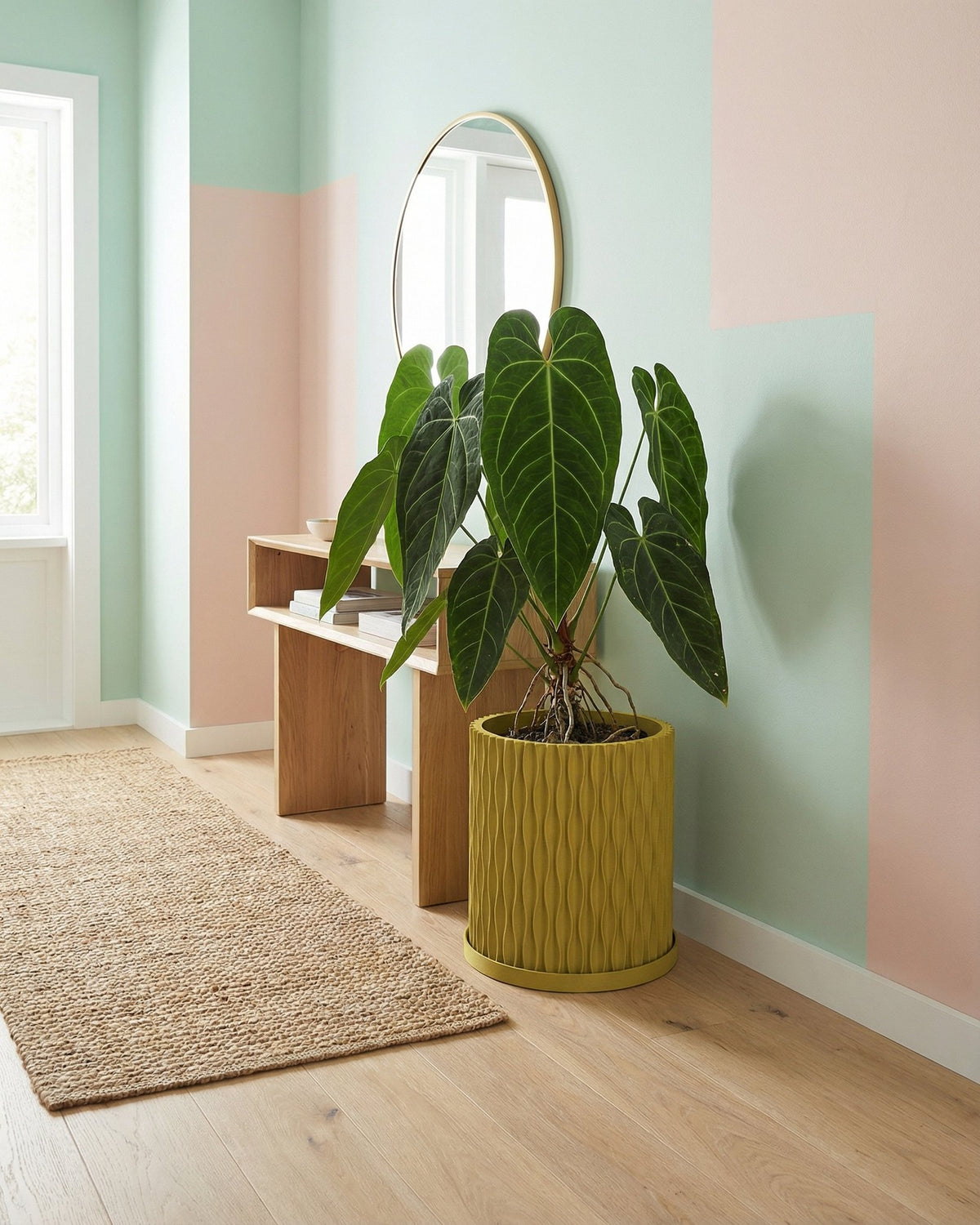A vibrant pothos plant cascades from a textured, olive-green planter pot, sitting on a dark wood surface.